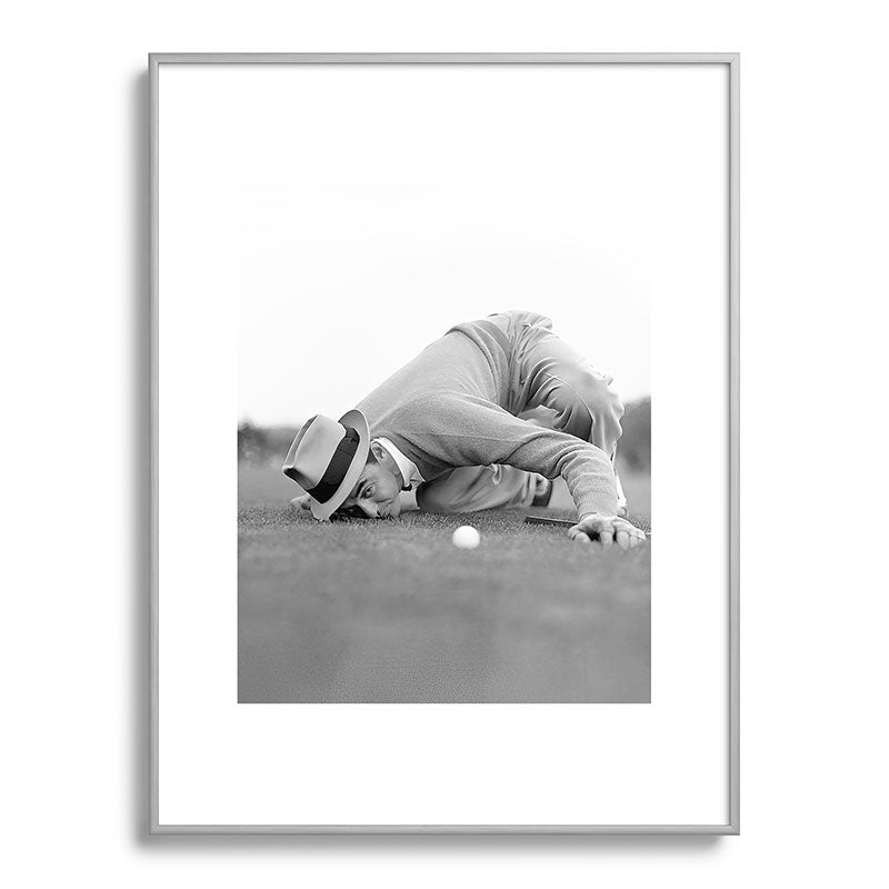 Eye to the ground on the 18th hole; golfing man eyes ball to measure distance to hole vintage black and white portrait photograph - photography - photographs poster Framed Art Print Gallery Image 134