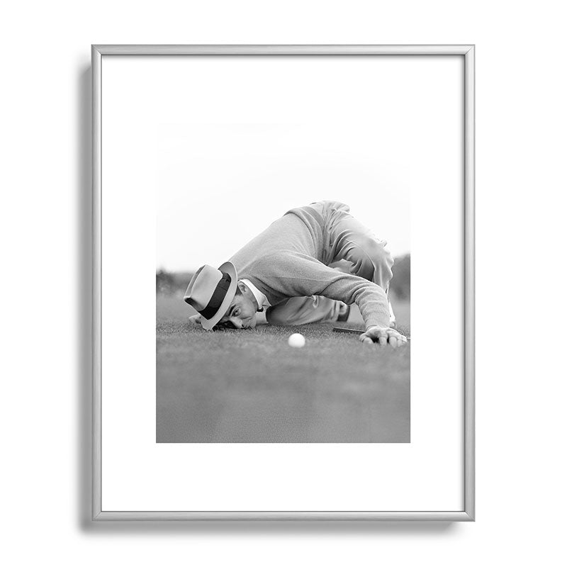 Eye to the ground on the 18th hole; golfing man eyes ball to measure distance to hole vintage black and white portrait photograph - photography - photographs poster Framed Art Print Gallery Image 129