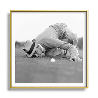 Eye to the ground on the 18th hole; golfing man eyes ball to measure distance to hole vintage black and white portrait photograph - photography - photographs poster Framed Art Print Gallery Image 133