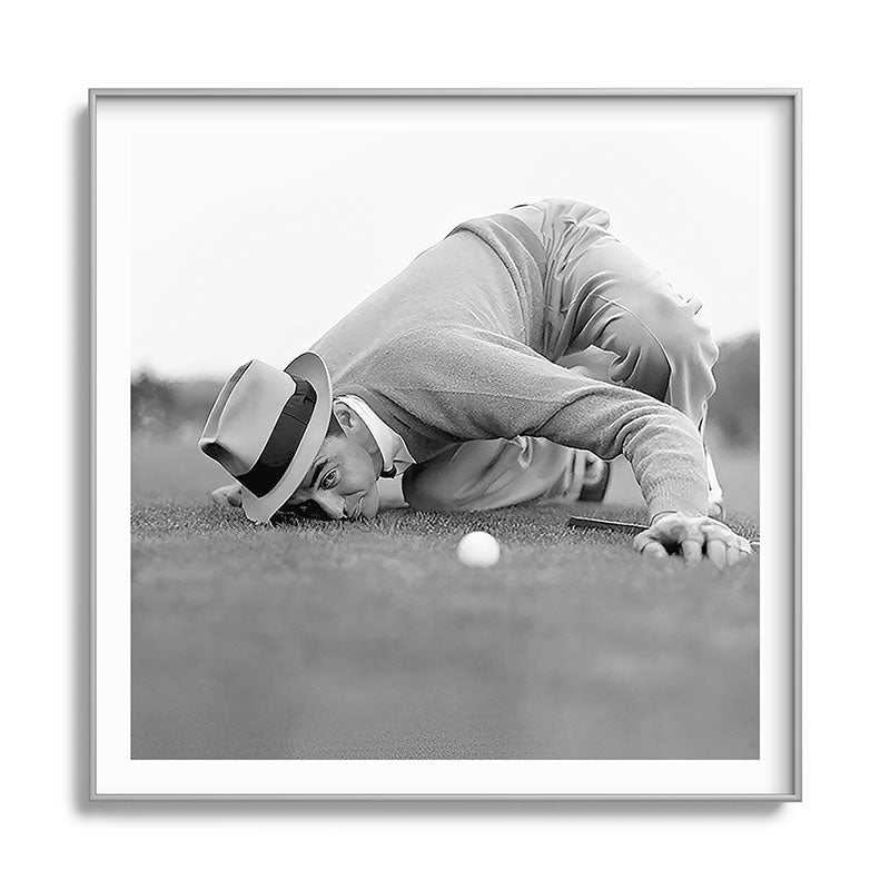 Eye to the ground on the 18th hole; golfing man eyes ball to measure distance to hole vintage black and white portrait photograph - photography - photographs poster Framed Art Print Gallery Image 141
