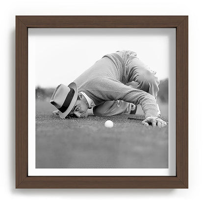 Eye to the ground on the 18th hole; golfing man eyes ball to measure distance to hole vintage black and white portrait photograph - photography - photographs poster Framed Art Print Gallery Image 98